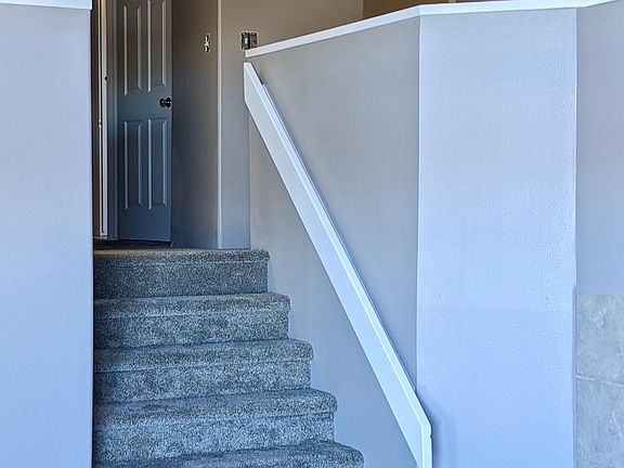 Split-level stairs to living room from kitchen/dining area