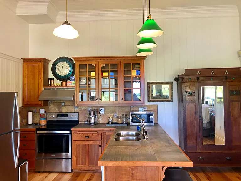 Your Carriage House Kitchen is outfitted with custom-made solid cherry wood cabinets, full-size stainless steel appliances including brand new oven, frig, microwave, toaster. Penomenal breakfast bar that seats up to four guests.