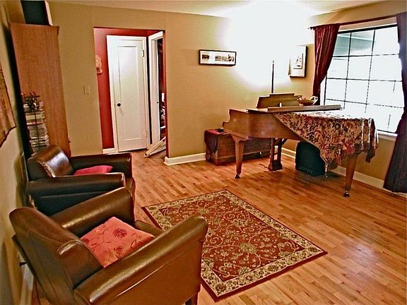 Living room offers a dining area and hardwood floors.