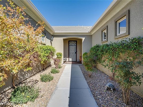 Landscaped courtyard leading to front door! Notice security wrought iron door!