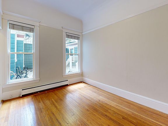 Spacious living room with wood-like flooring and large windows