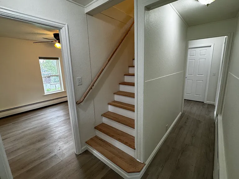 Hallway to dining room, kitchen, staircase, bathroom, and master bedroom.