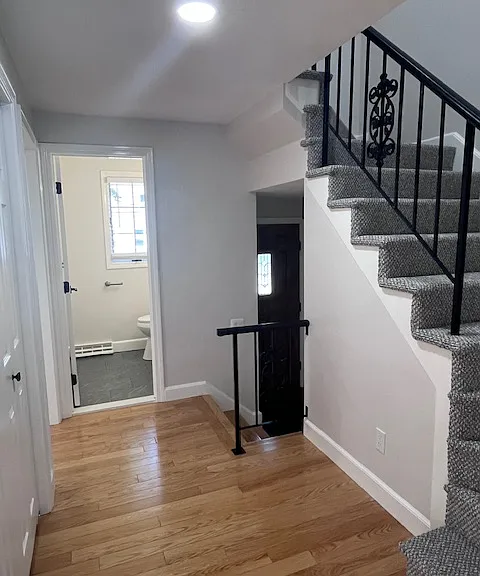 Hallway with closet, brand new carpet on staircase.