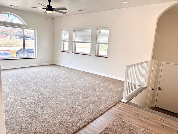 View walking into apartment: front door leads up a small flight of stairs into the living room. Tons of beautiful natural light and views of the canyons!
