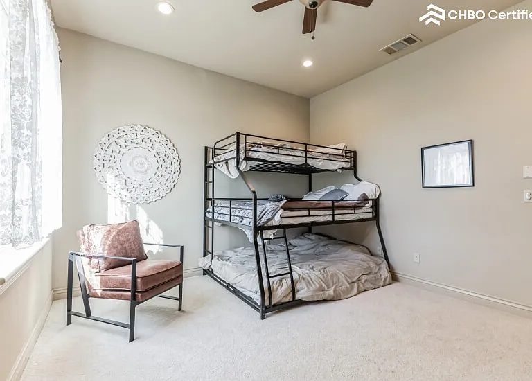 Triple bunk with shared bathroom. View of front yard