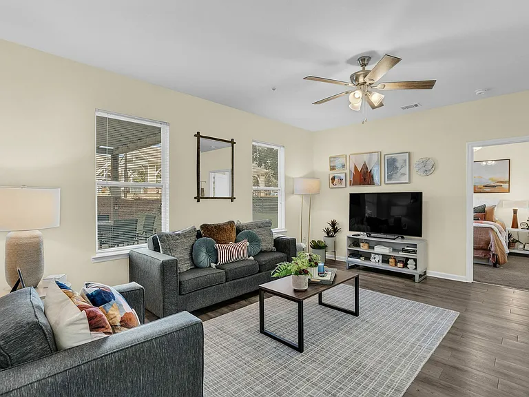 Relax in the cozy living room of your spacious student apartment at The Flatts Starkville, designed for comfort.