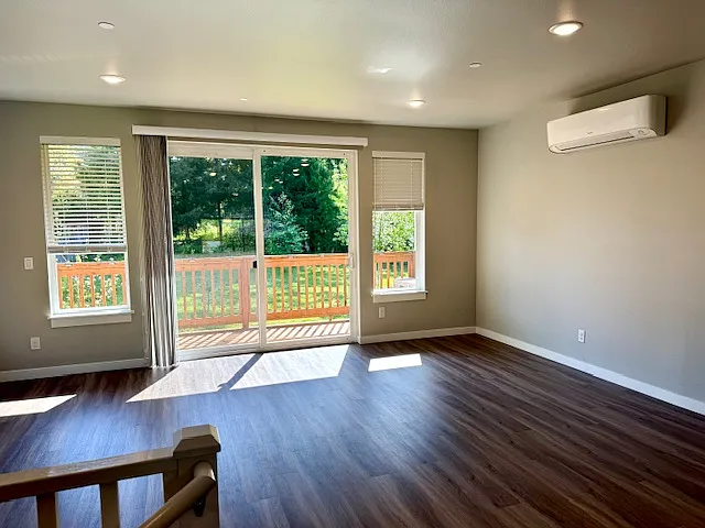 Spacious Great Room gets lots of Natural light. Luxury vinyl plank flooring throughout the main level.
Plus, an efficient mini-split HVAC system

LED can lighting and an oversized sliding door open onto a large cedar deck overlooking the greenbelt behind