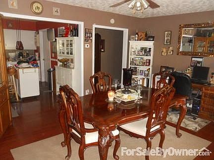 Dining room with kitchen
						:
						Laminate wood flooring in dining room/kitchen/hallway.