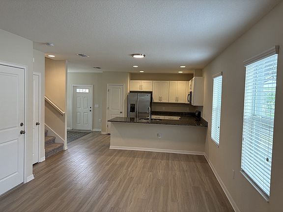 Spacious open-concept living area with oversized granite island and modern kitchen.