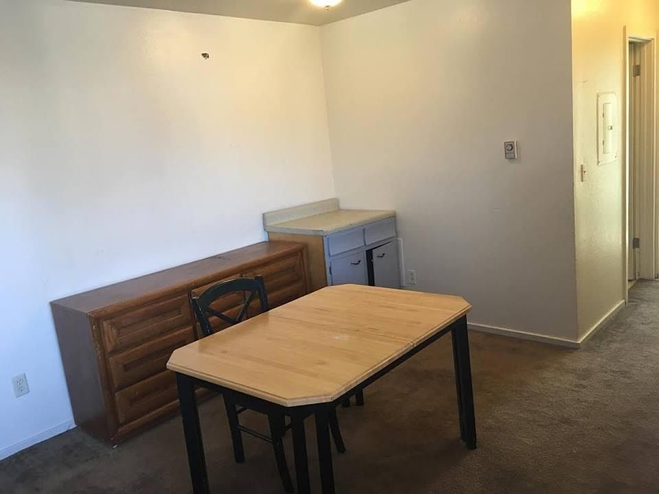 living room with a desk, drawers, and cabinet