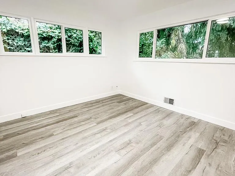 One of two bedrooms on main floor. Large closet and plenty of room for a King Bed. Lot's of light with windows on both sides.