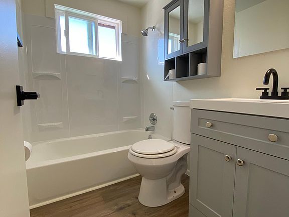 Brand new updated bathroom! New tub, vanity, mirror, storage, light fixtures, etc.