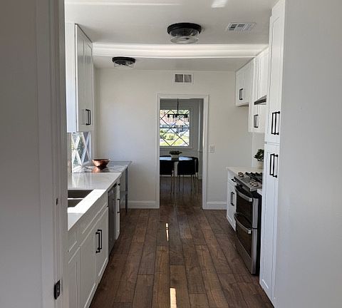 view from laundry room looking through kitchen to dining room
