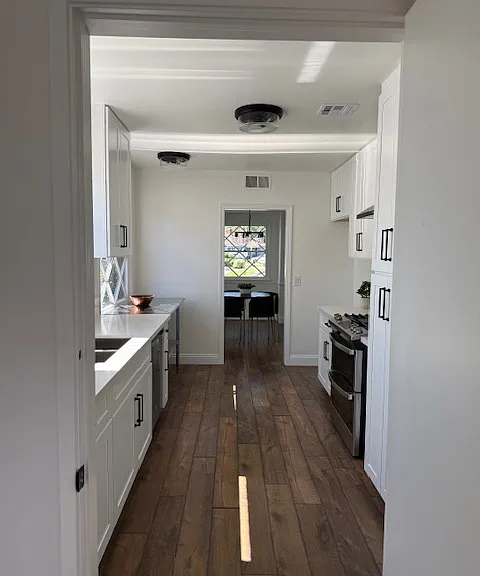 view from laundry room looking through kitchen to dining room