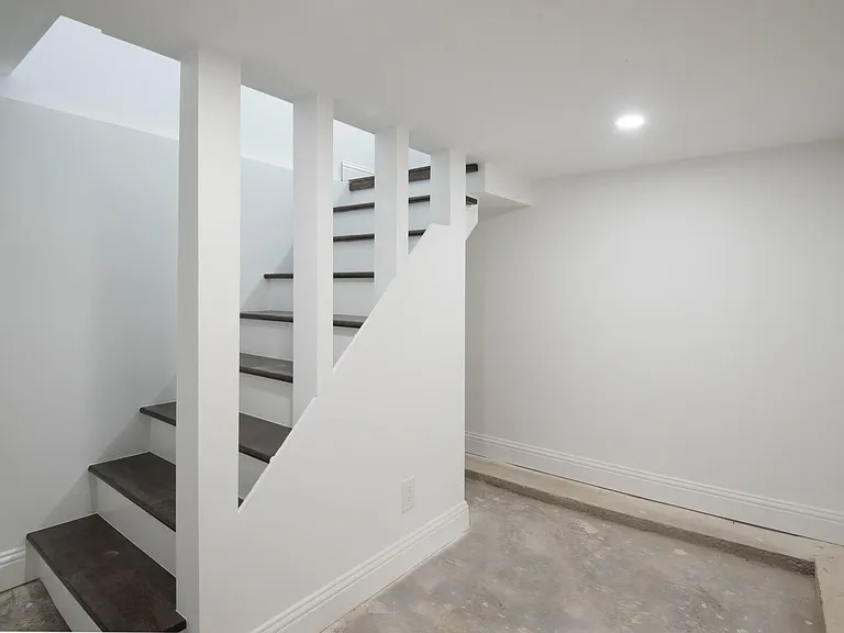 Finished area in basement (now has flooring) for small office or storage. Unfinished area of basement not shown.