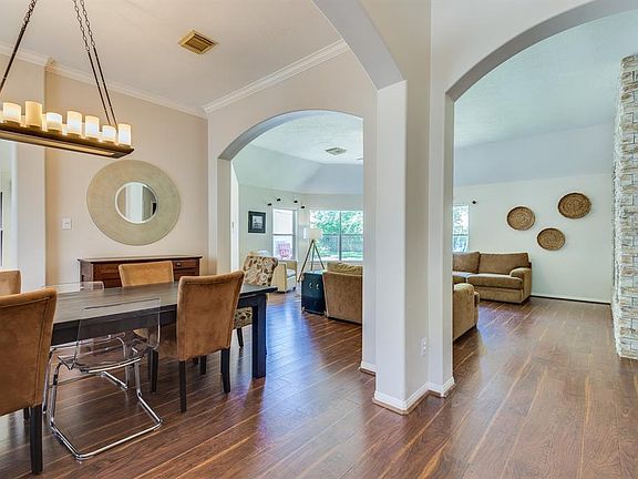 ARCHWAYS LEAD TO THE DINING ROOM AND DEN.