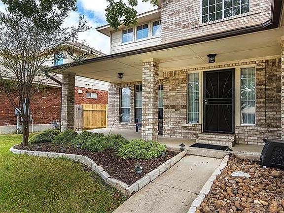 Front of home, beautiful patio and easy to manage landscaping. Extra security, heavy duty screen doors on front and back.