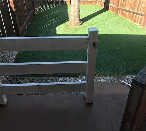 Private, gated front porch w/artificial turf (low maintenance). Also has hose attachment hook up