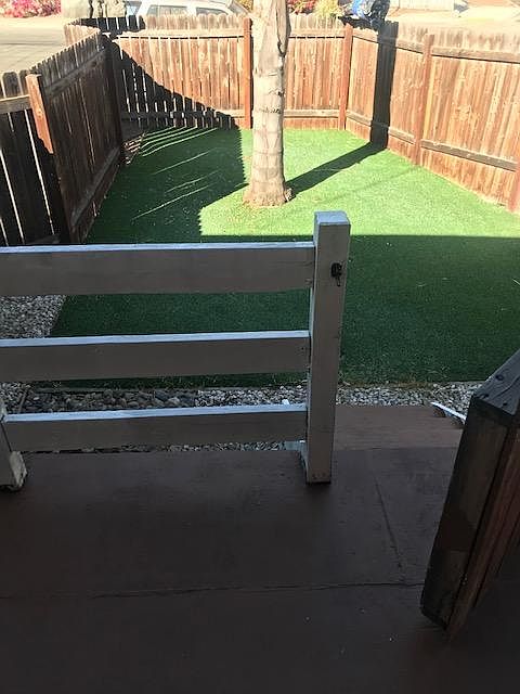 Private, gated front porch w/artificial turf (low maintenance). Also has hose attachment hook up