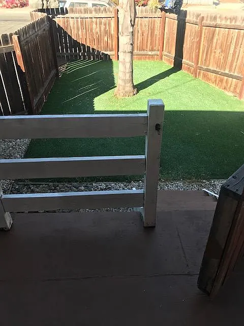 Private, gated front porch w/artificial turf (low maintenance). Also has hose attachment hook up