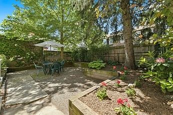 Common fenced-in back patio and garden