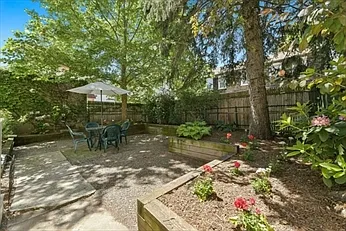 Common fenced-in back patio and garden - 63 Bakersfield St #2