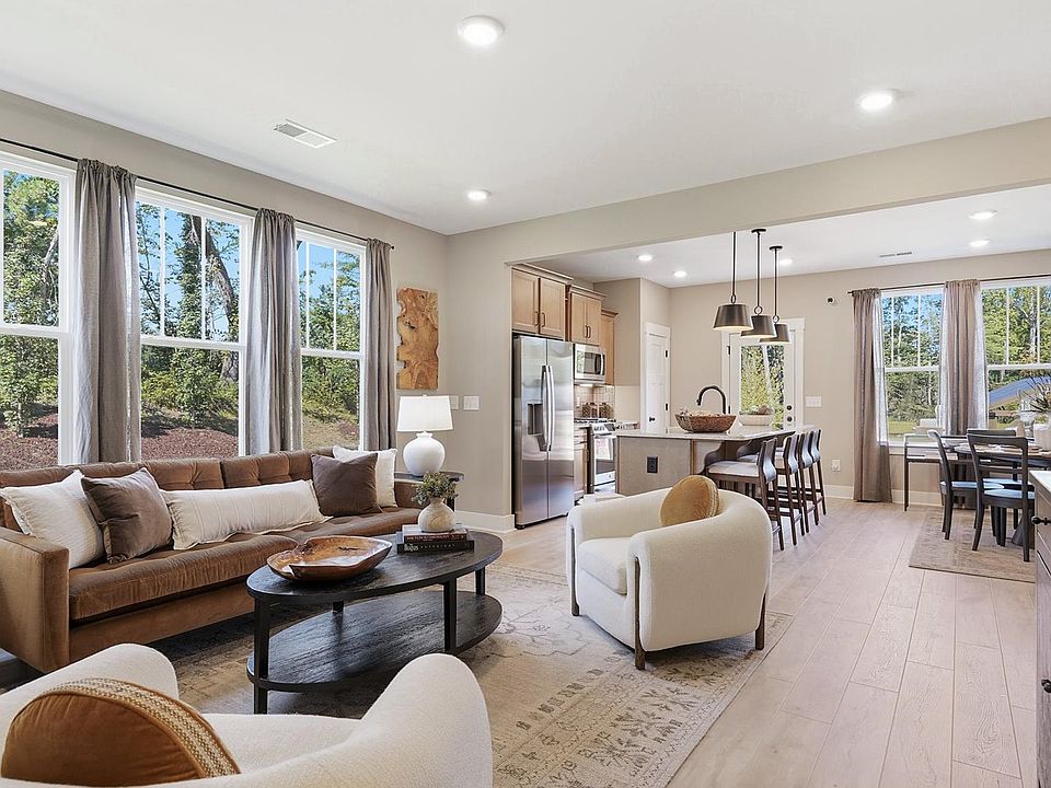 Hardwood flooring and high standards define this vibrant family room ideal for everyday living at Br