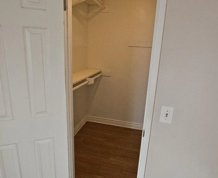 Walk-in closet with shelves on both sides. 5'x 5'