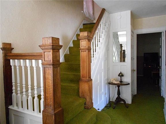 Beautiful wooden Newel posts are seen as you enter the front door.