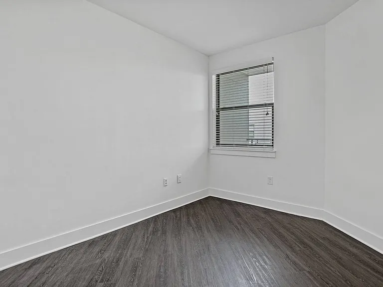 Wood-style flooring extends to the bedroom