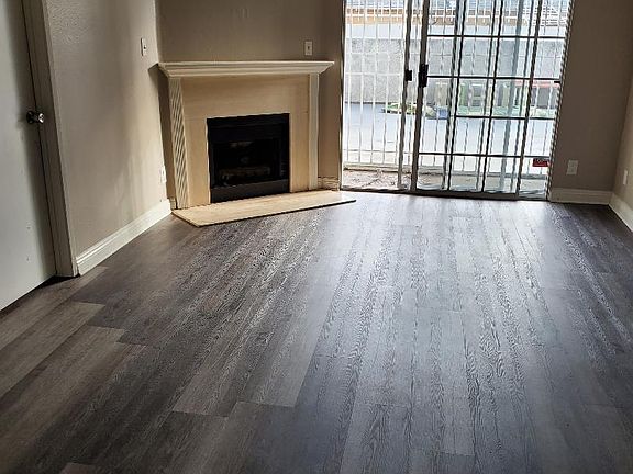Living room with open floor plan and gas fireplace