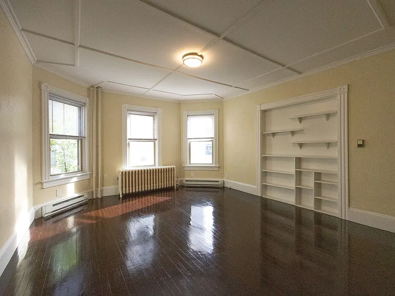 Bright living room with hardwood floors and multiple windows