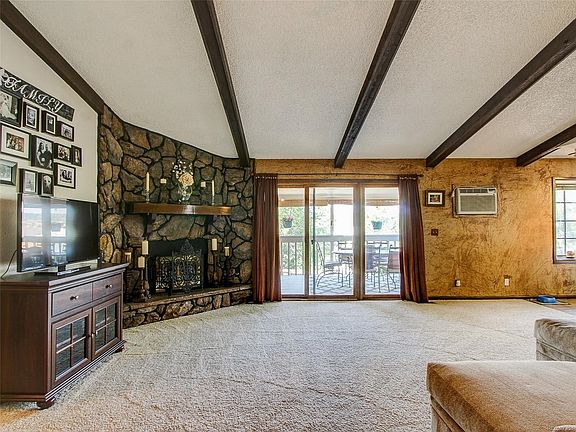 MAIN LEVEL GREAT ROOM. VAULTED CEILINGS. EXPOSED STAINED BEAMS.