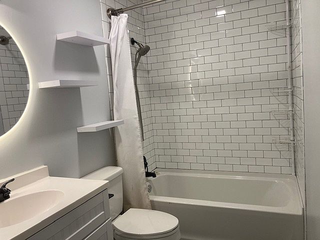 Bathroom with upgraded shower head, mirror, and storage