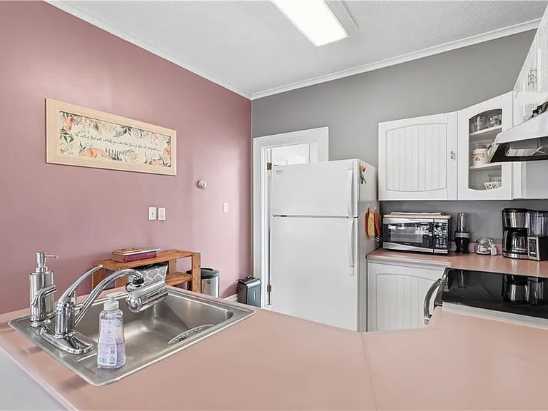 Kitchen with electric stove, refrigerator