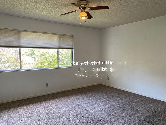 Bedroom 1 has a large window, 2 large closets, and a ceiling fan.