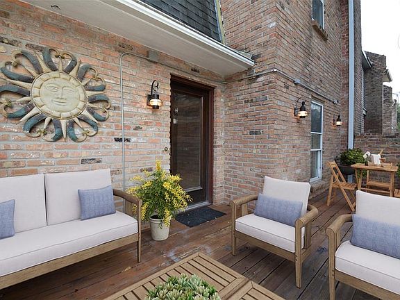 View of the front courtyard/deck which has been virtually staged to give you an idea of the possibilities with this amazingly versatile space.