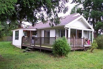 This picture is showing the side of the home and the large deck.