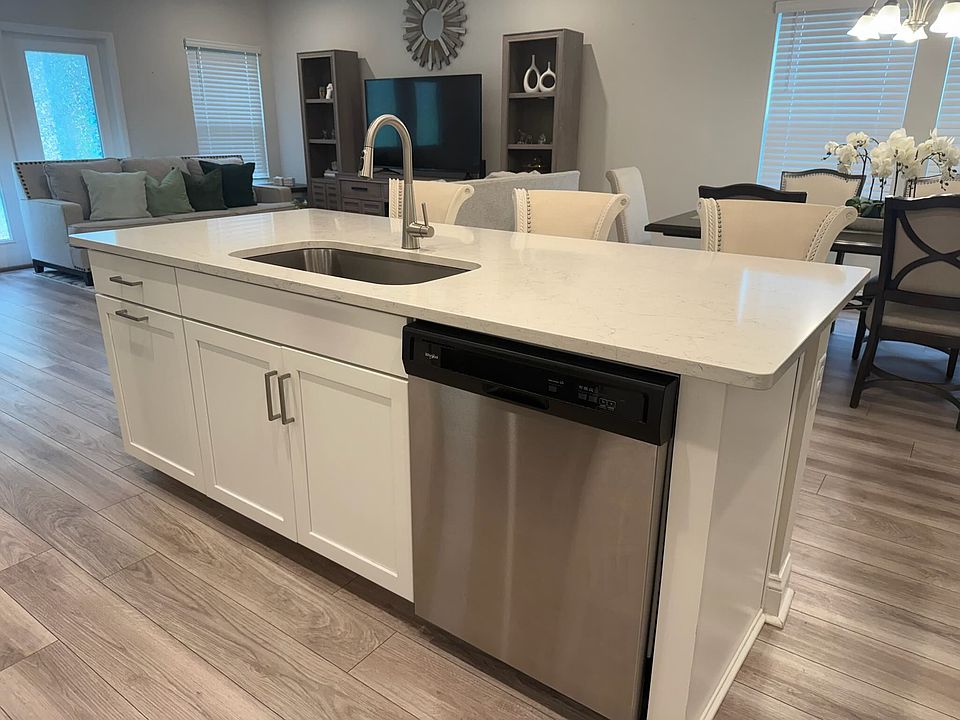 Oversized island with seating and integrated sink, perfect for casual dining and entertaining.