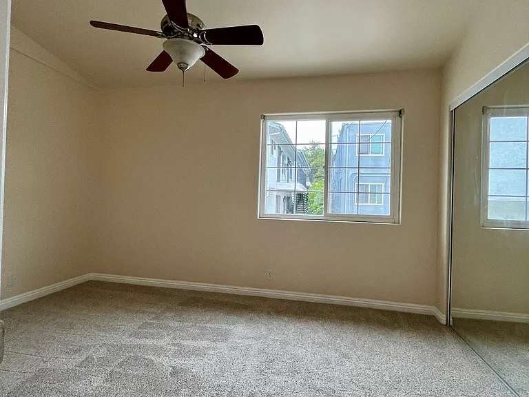 Peaceful bedroom space filled with natural light and fresh new carpeting