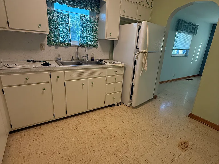 Kitchen. Arched pass through into the dining room.