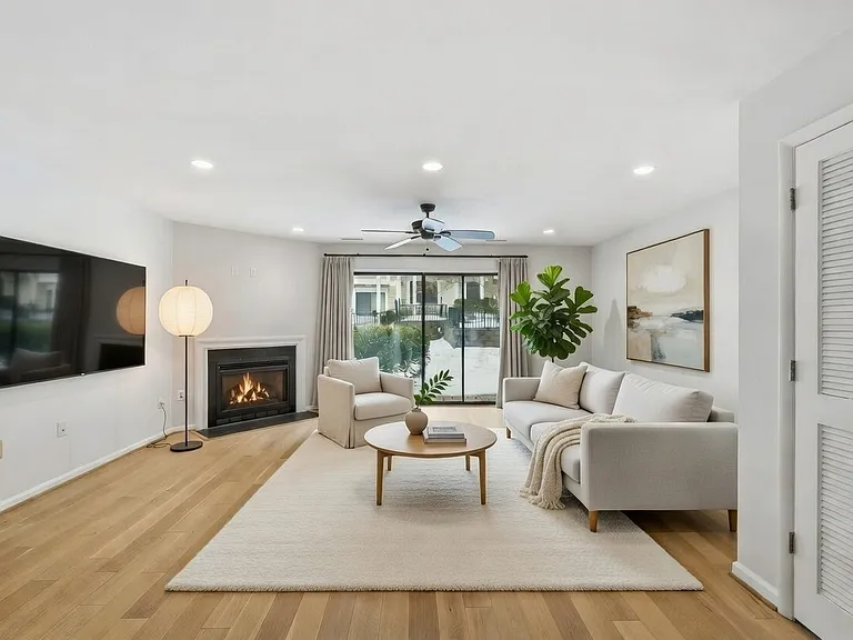 living area with fireplace and patio view