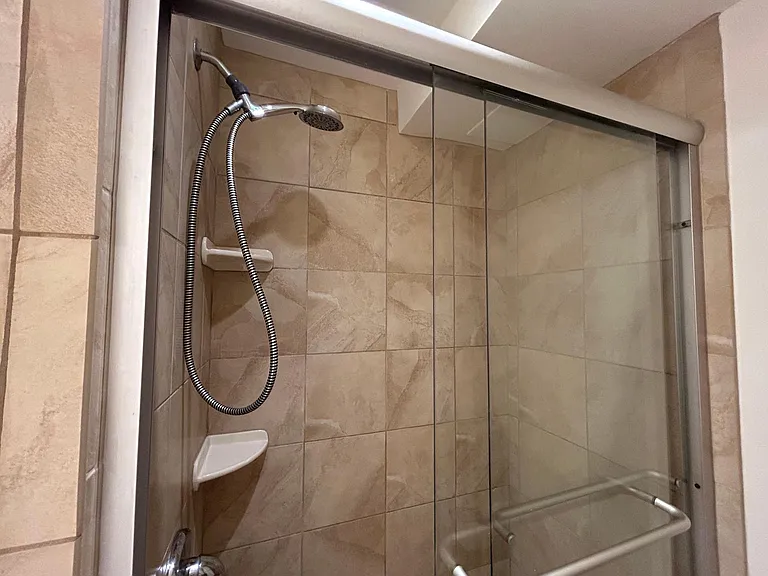 Glass-enclosed shower stall