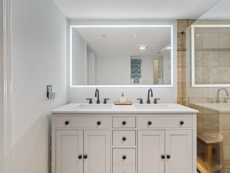 Spacious lower level bathroom off of the third bedroom and adjacent to a large walk-in closet. Large walk-in shower with glass shower surround.