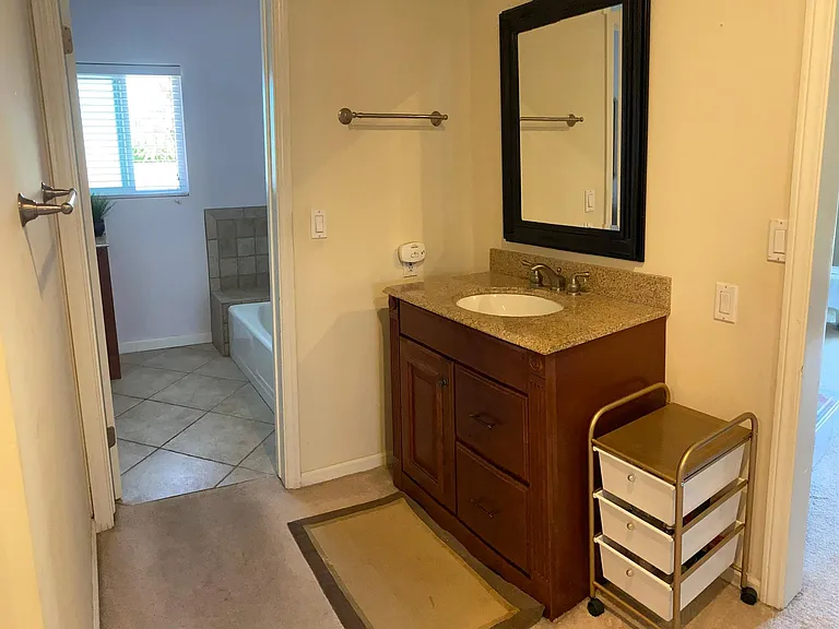 Additional sink vanity outside master bath.