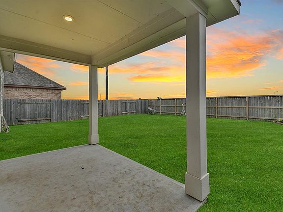 Cover back patio overlooking the large back yard.