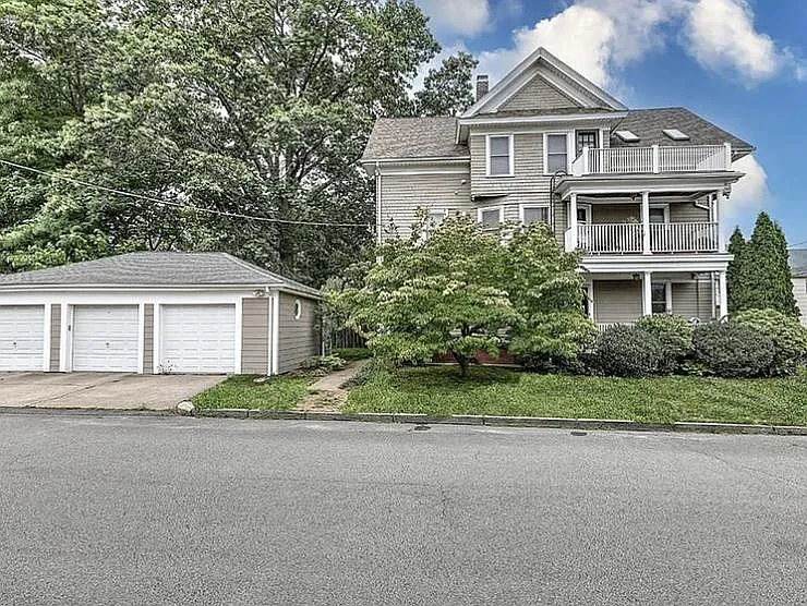 Side of house with balconies and private garage units