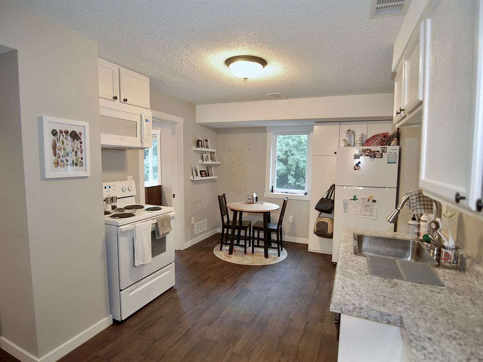 Kitchen includes dishwasher, microwave venthood, pull-out sink faucet, range, and refrigerator.