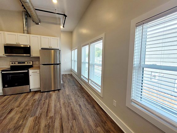 Wall to wall windows within the span of all living spaces - leading to rear of unit