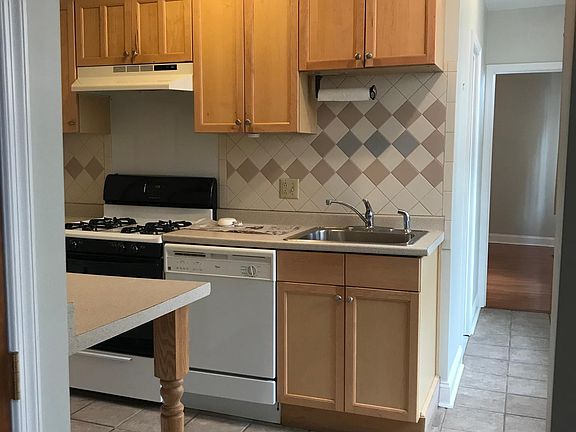 Apartment entrance to the kitchen on the left and living room on the right.
